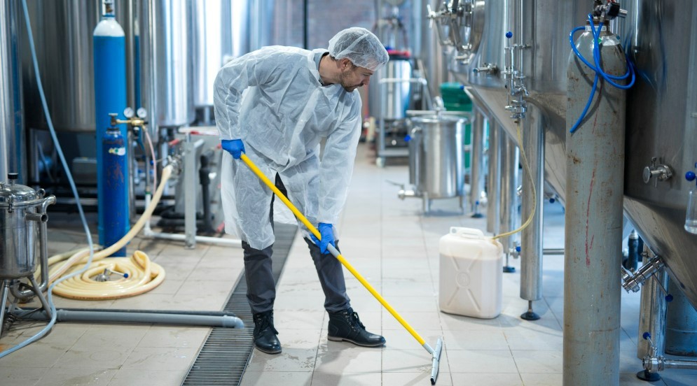 professional-industrial-cleaner-in-protective-uniform-cleaning-floor-of-food-processing-plant-2